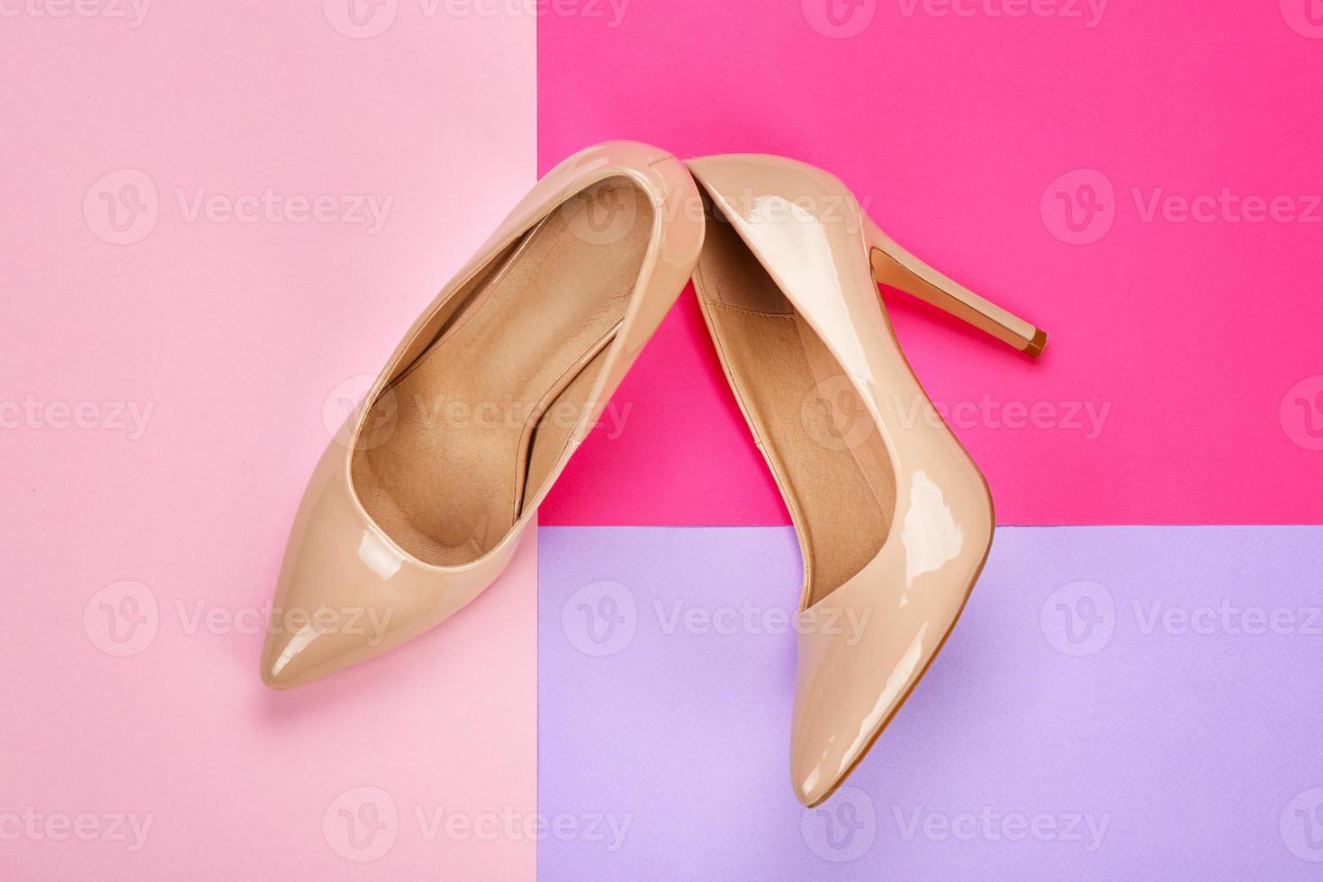 Stylish female shoes on color background photo