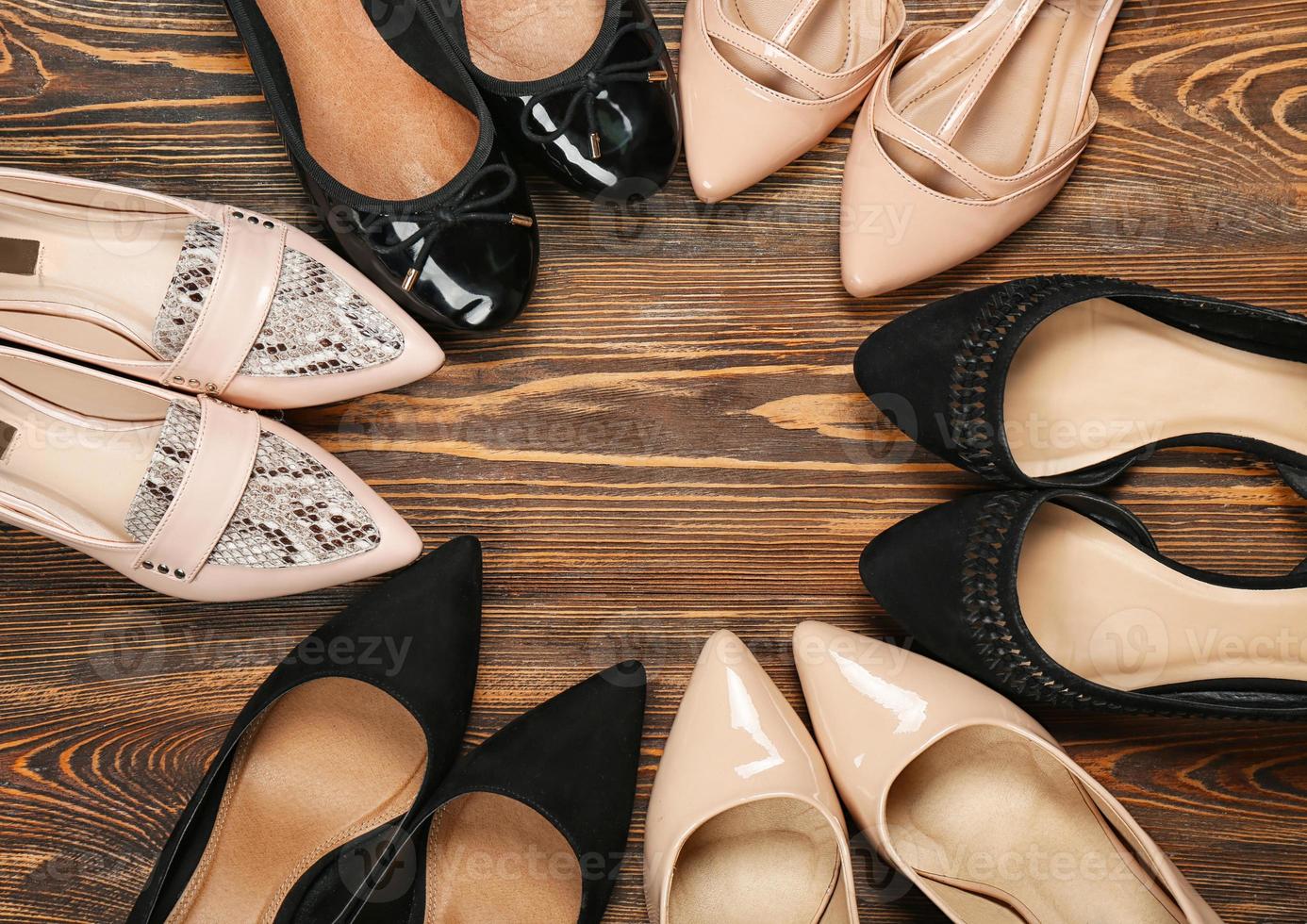 Female stylish shoes on wooden background, top view photo