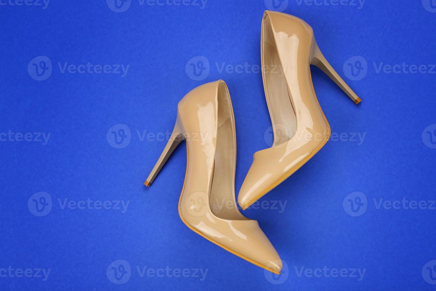 Stylish female shoes on color background photo