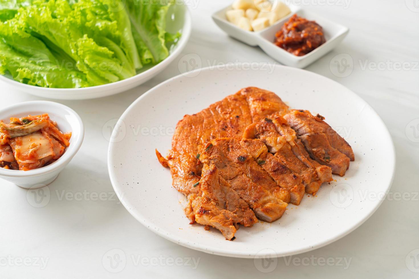 cerdo asado en salsa kochujang marinado al estilo coreano con verduras y kimchi foto