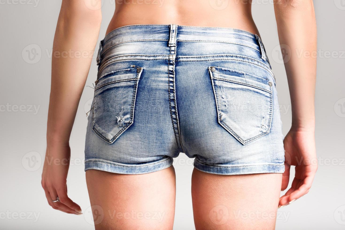 Back view of woman wearing denim shorts photo