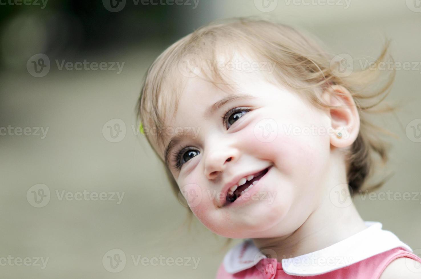 Little girl playing in a urban park photo