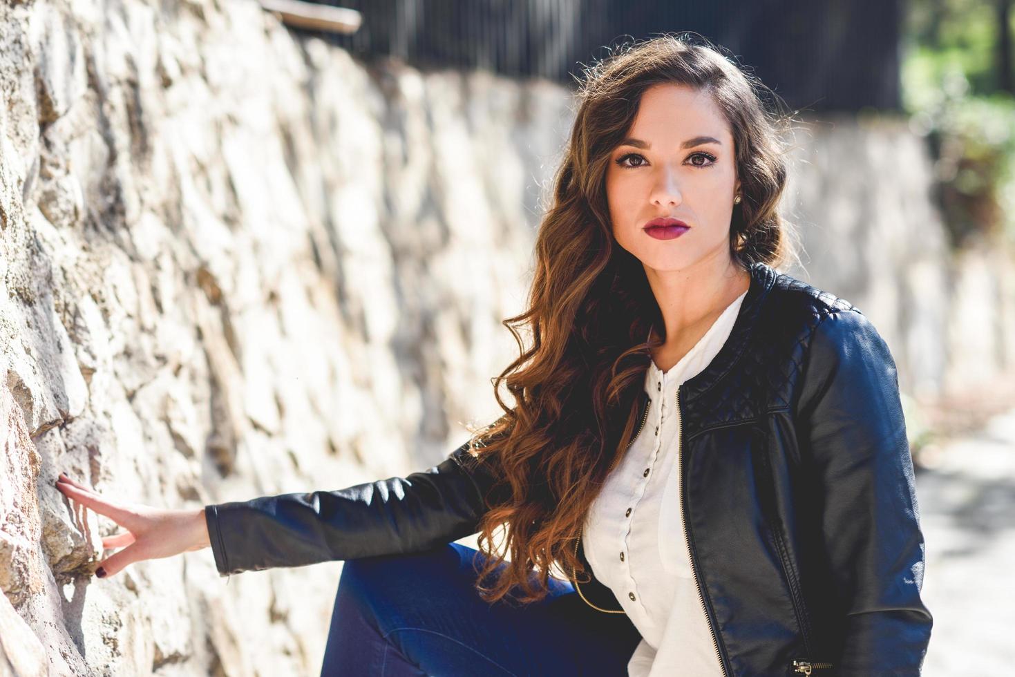 Girl with long hair wearing leather jacket photo