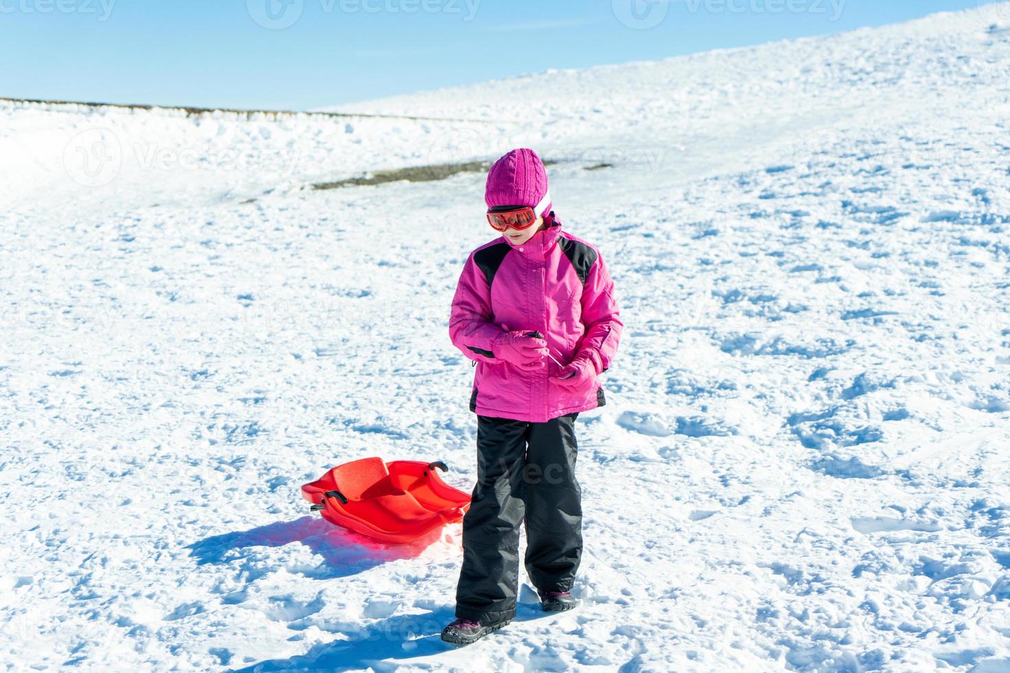 Little girl sledding at Sierra Nevada ski resort. photo