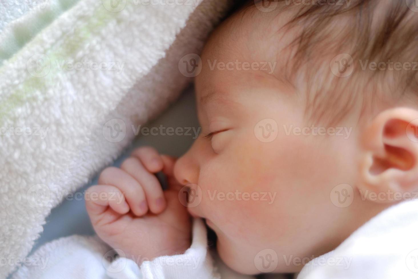 Newborn baby girl in hostpital bed sleeping photo