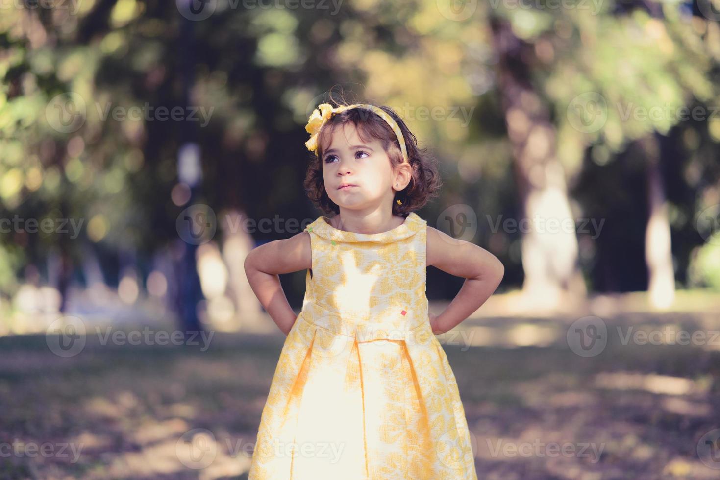 Little girl running and playing in the park photo