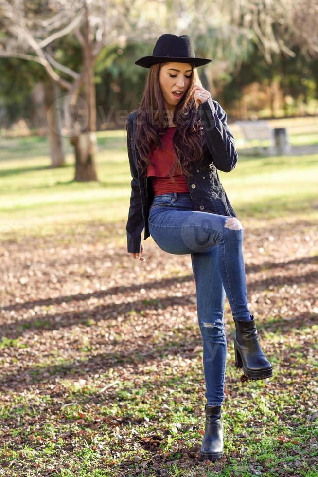 Portrait of young woman smiling in urban park photo