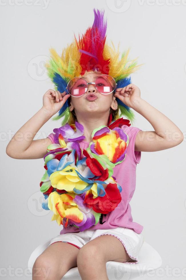 Funny little girl in disguise with wig and sunglasses photo