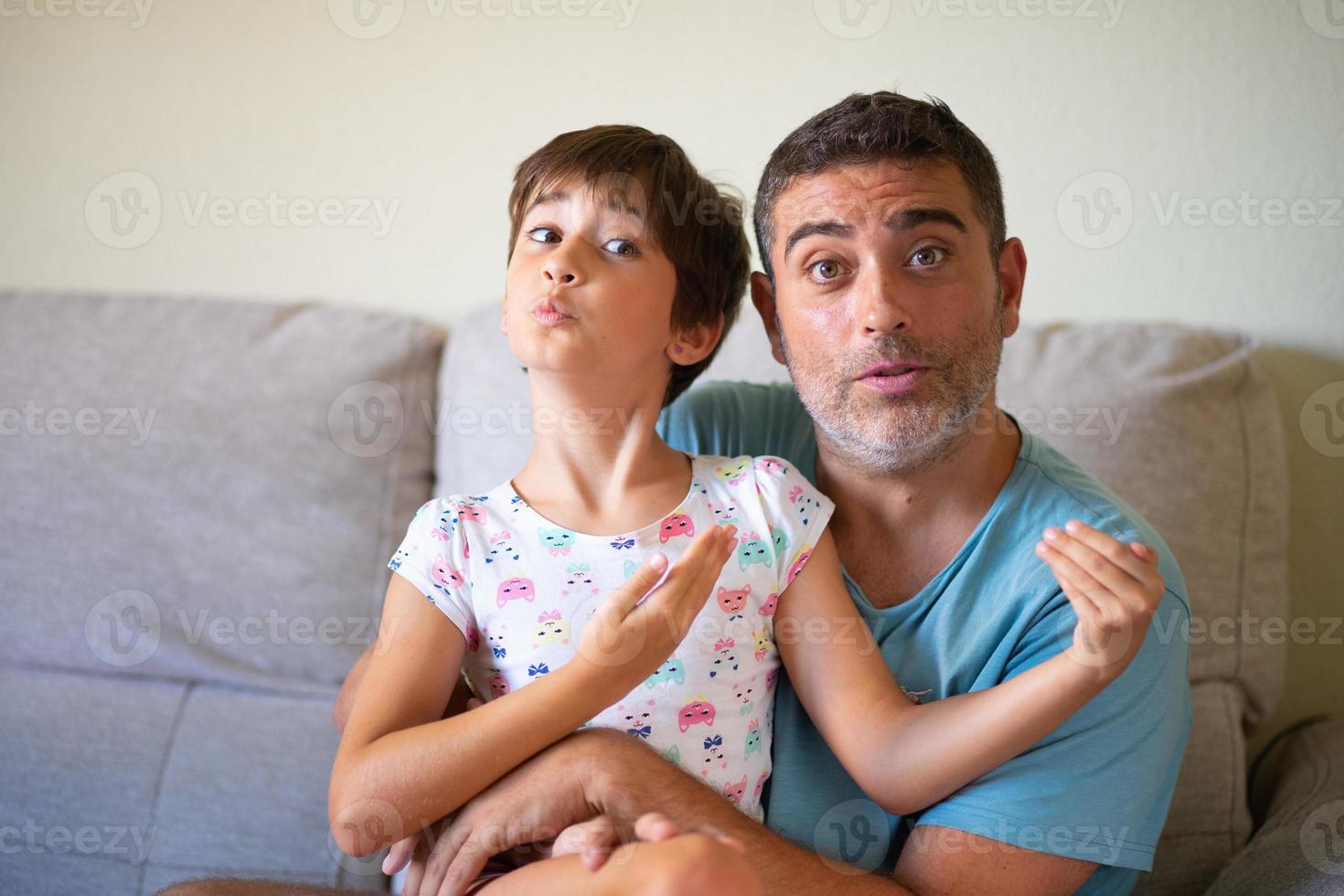 Little cute daughter doing make-up to her father photo