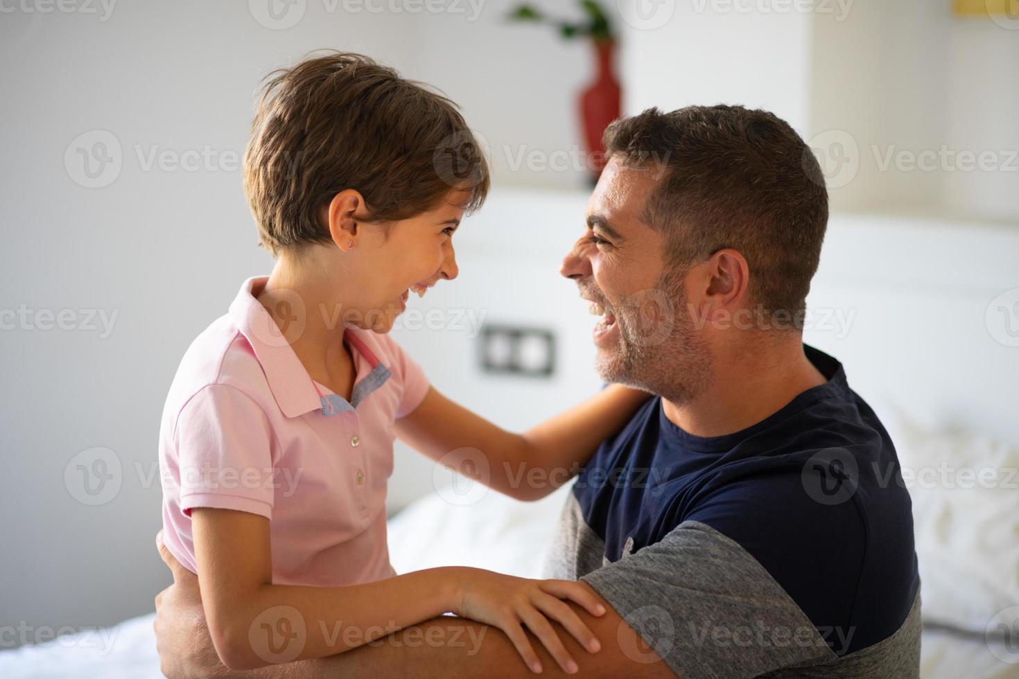 Middle-age man and her little daughter are hugging. photo