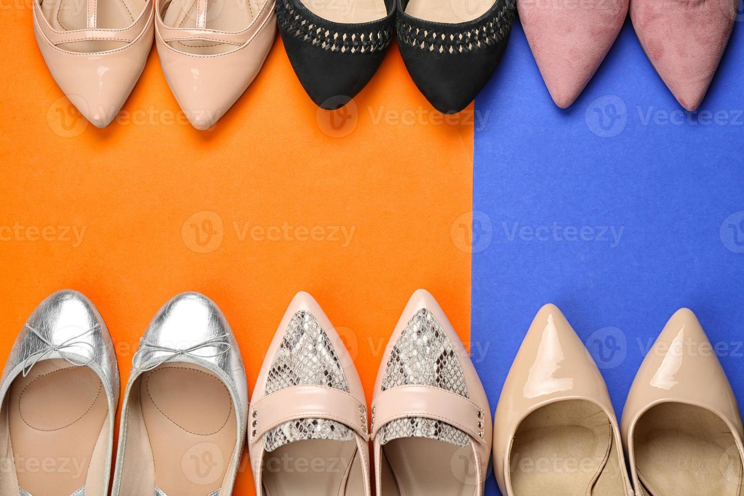 Elegant female shoes on color background photo