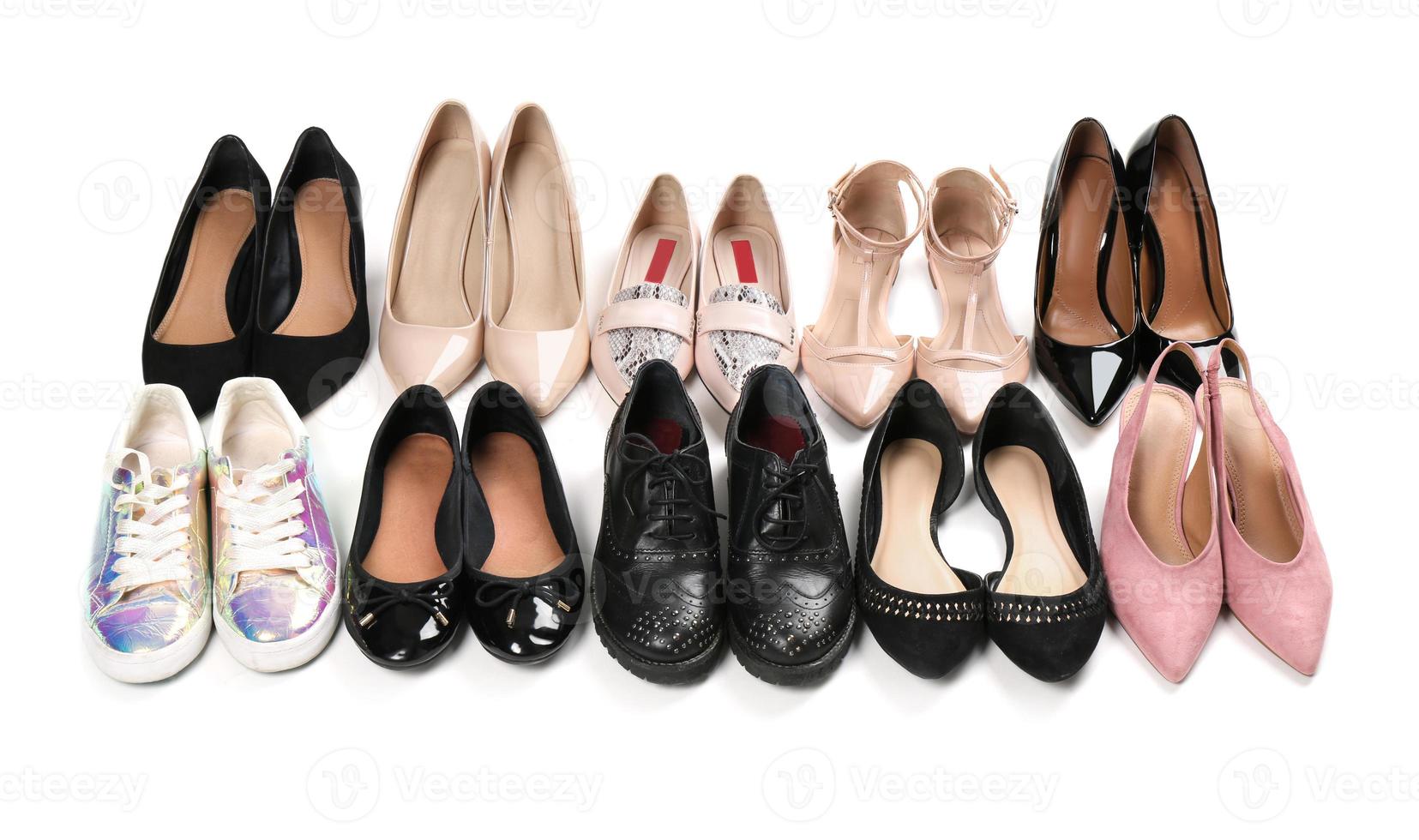 Various female stylish shoes on white background photo