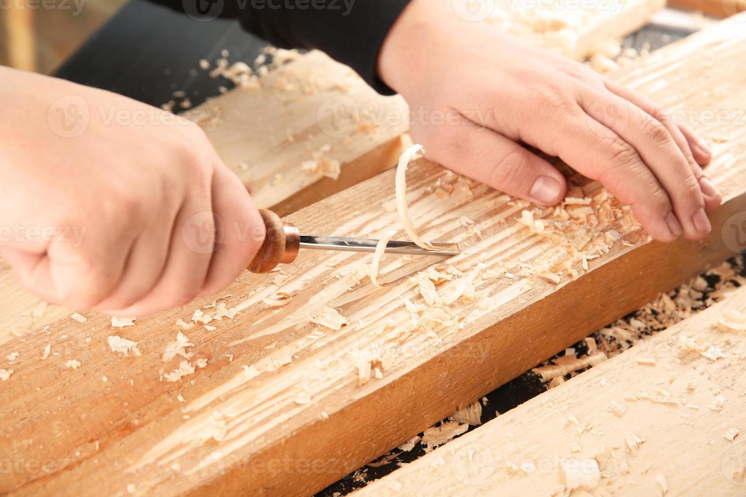 Carpenter working with chisel, closeup photo