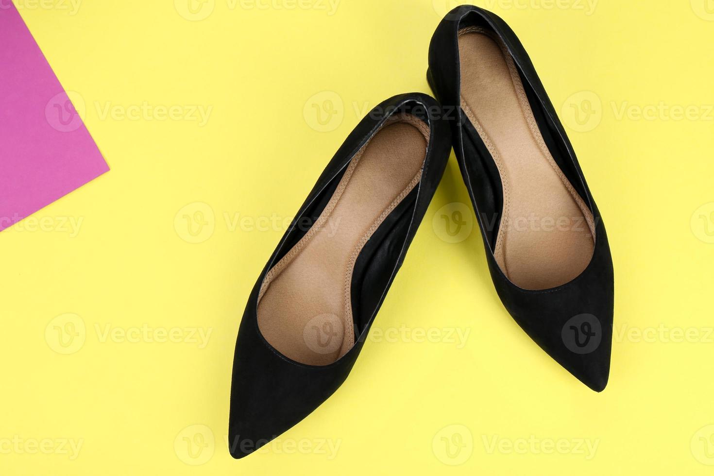 Elegant female shoes on color background photo