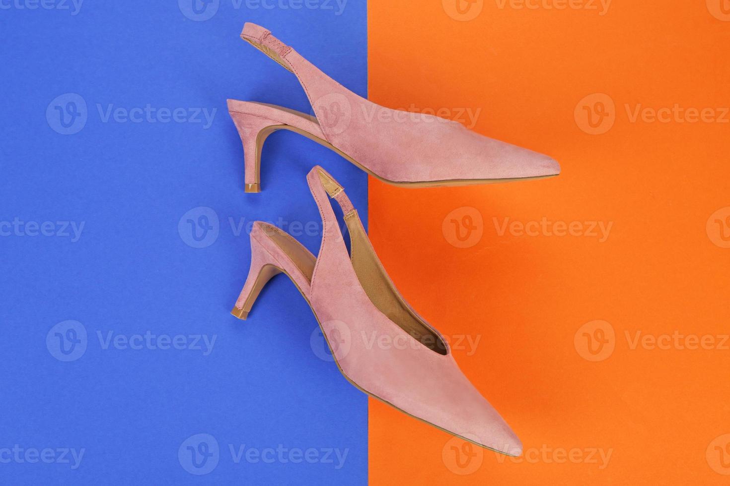 Elegant female shoes on color background photo