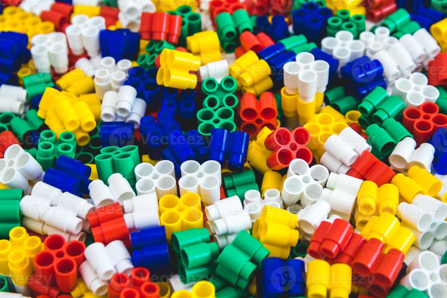 Multicolored plastic building blocks of the designer photo
