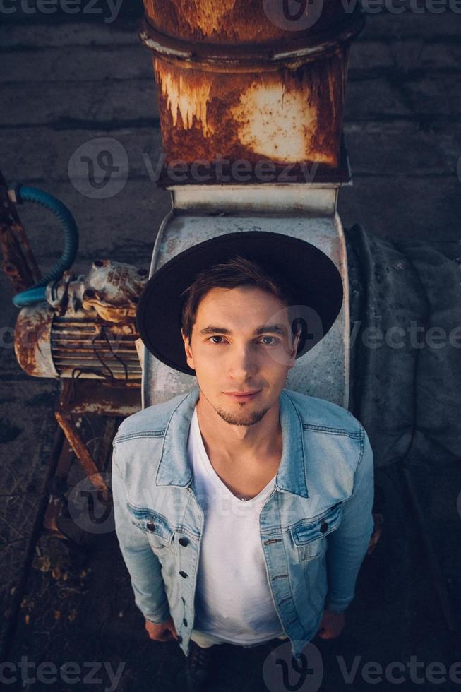 Urban man with hat against the background of city photo