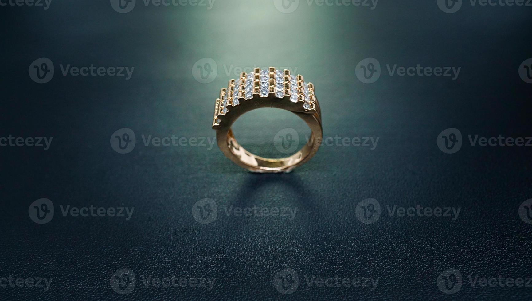 photo of women's ring that sparkles on a dark background