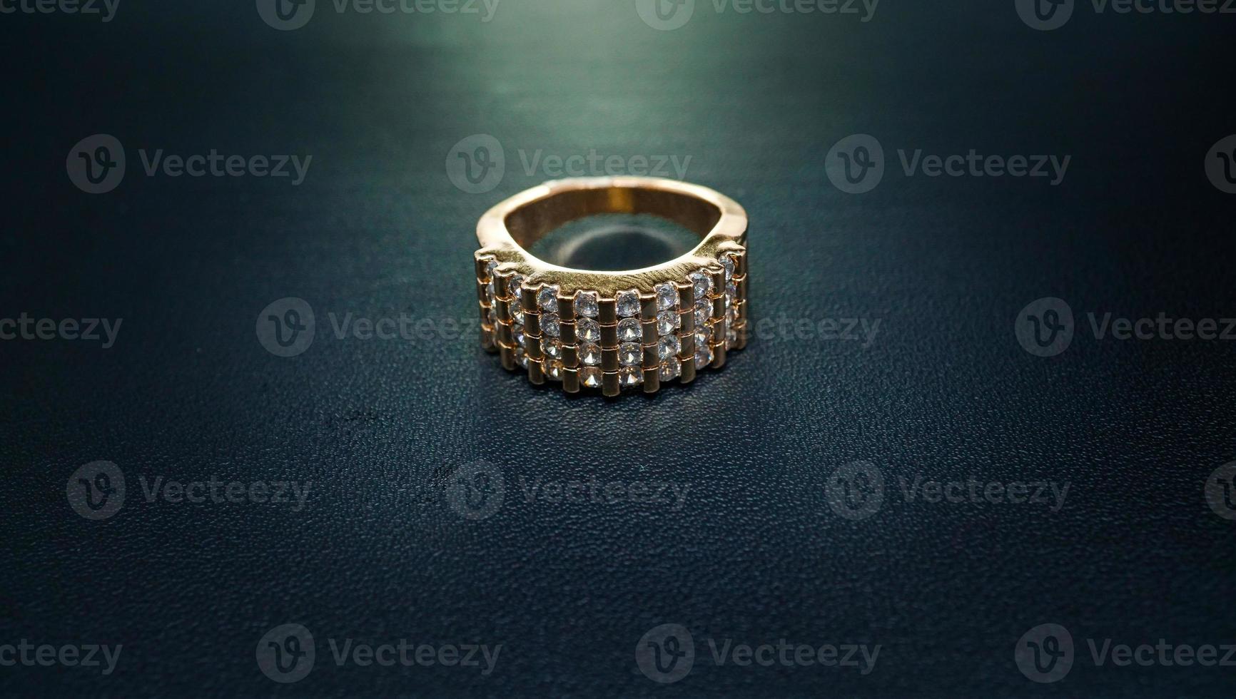 photo of women's ring that sparkles on a dark background