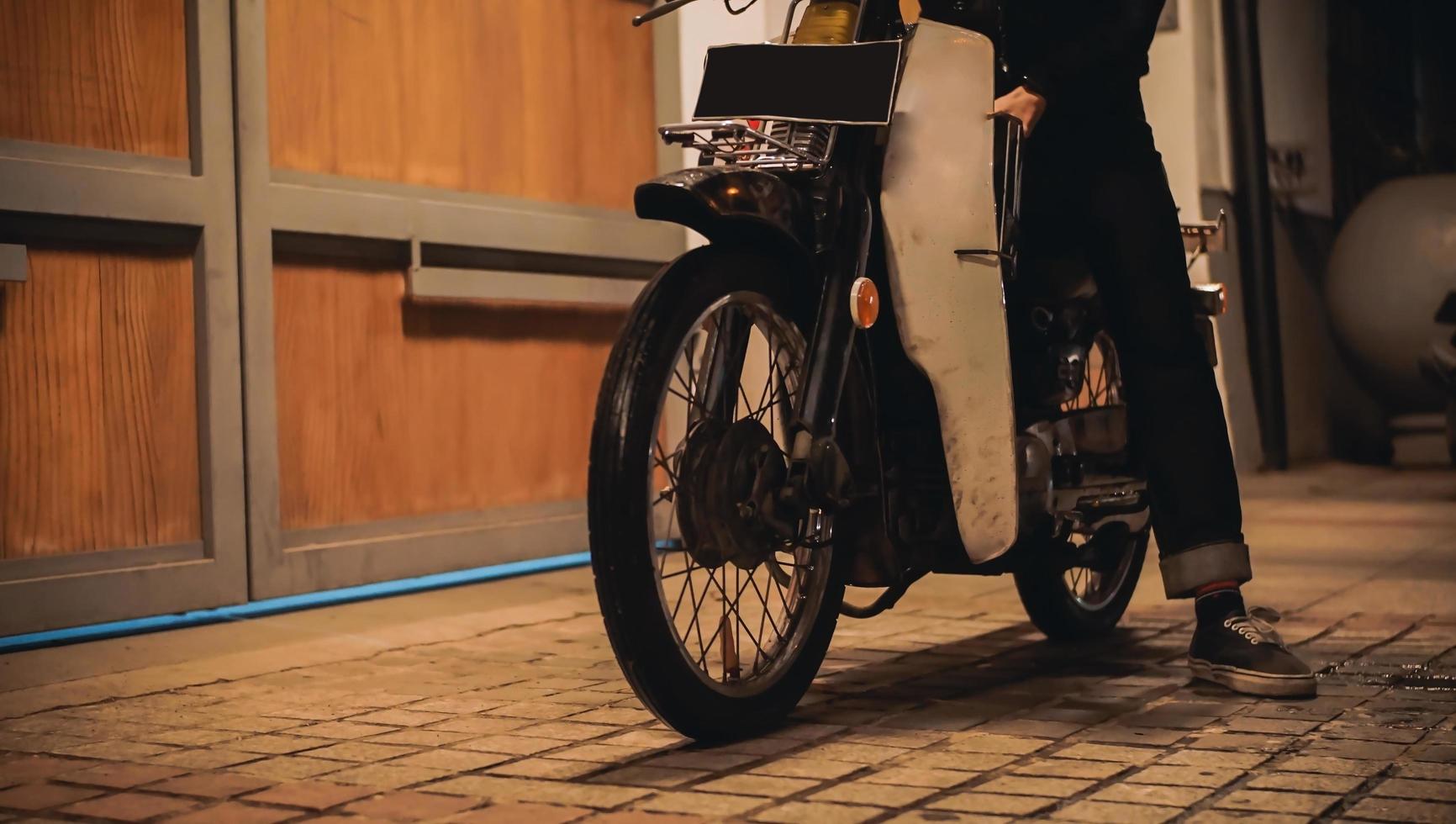 a man who uses an old antique motorcycle photo