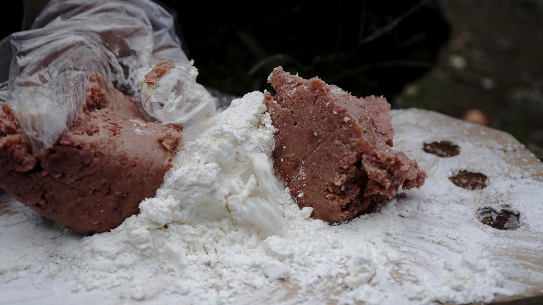 a young chef is making burger stuffing dough on the edge of a waterfall photo