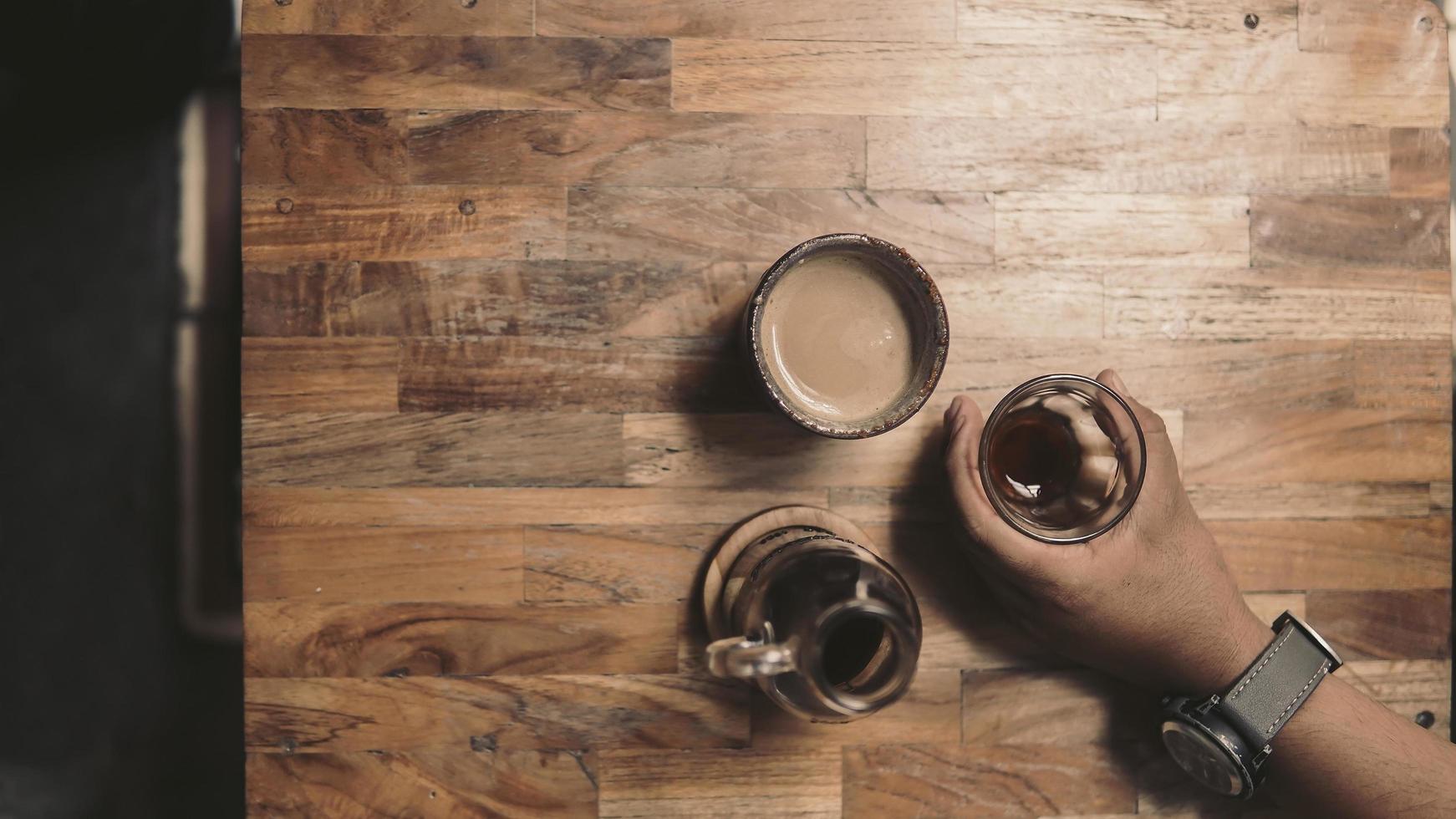male hand holding a cup of coffee v60 photo