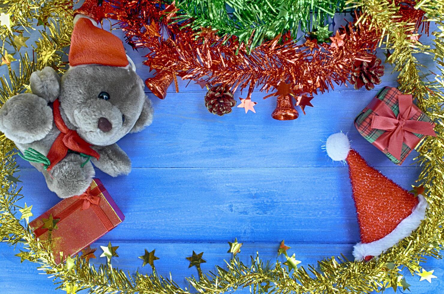 Christmas holiday background with teddy and Santa hat and decorations backgrounds above. Place for your text photo