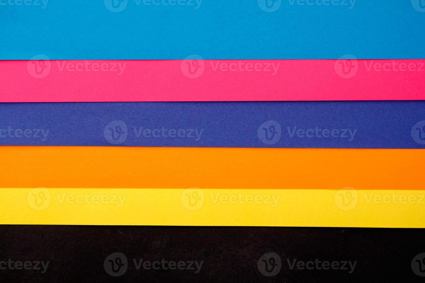 Colorful paper on black background photo