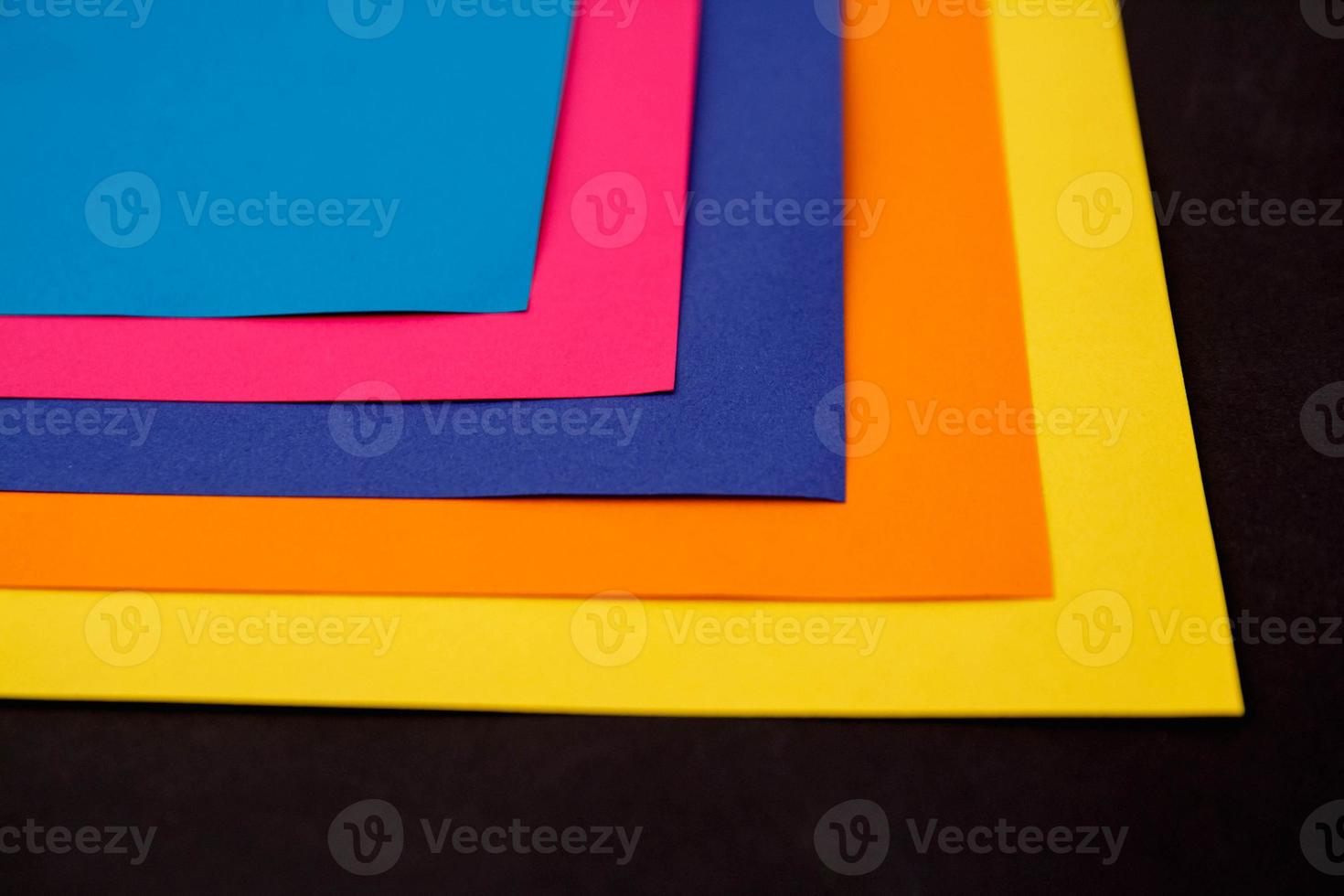 Colorful paper on black background photo