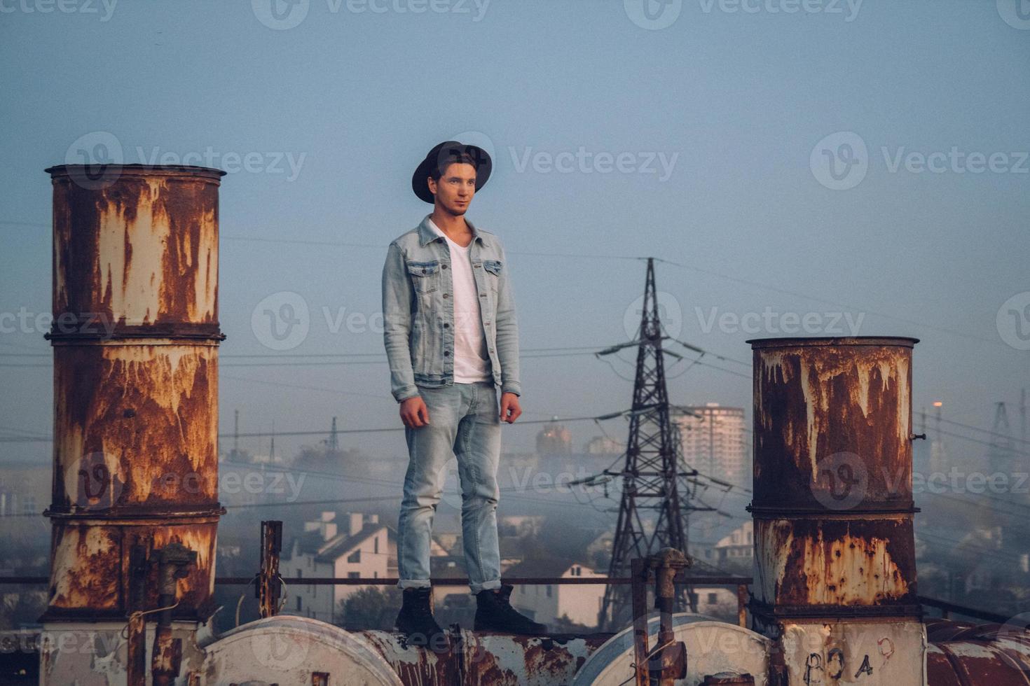 Urban man with hat against the background of city photo