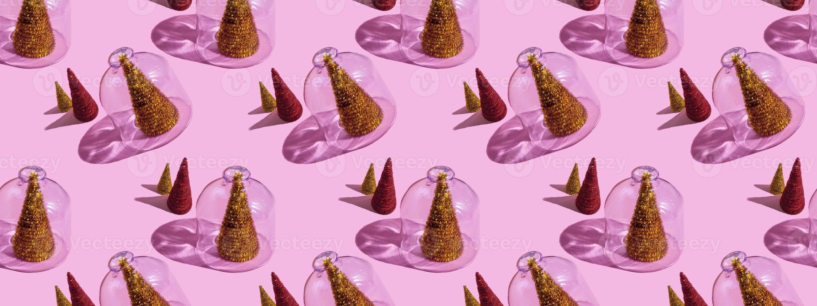 Christmas tree under glass on a pink background. Christmas concepts with copy space. New year and christmas concept in quarantine. Quarantine sample. photo