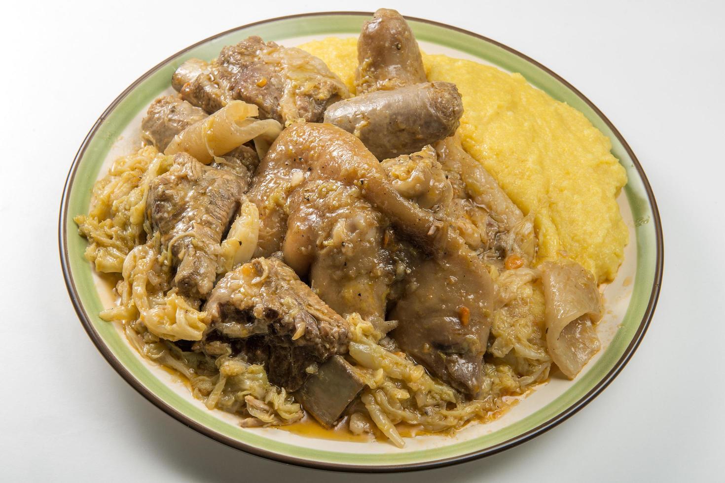 Dish of pork meat and savoy cabbage and cornmeal mush photo