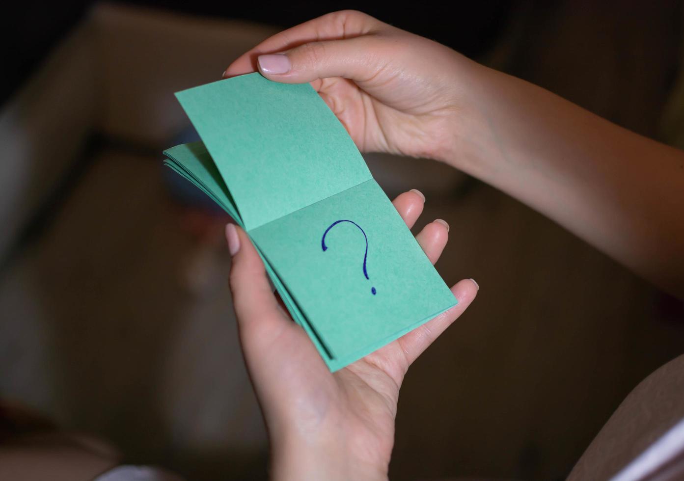 Look at a piece of paper with a question mark photo