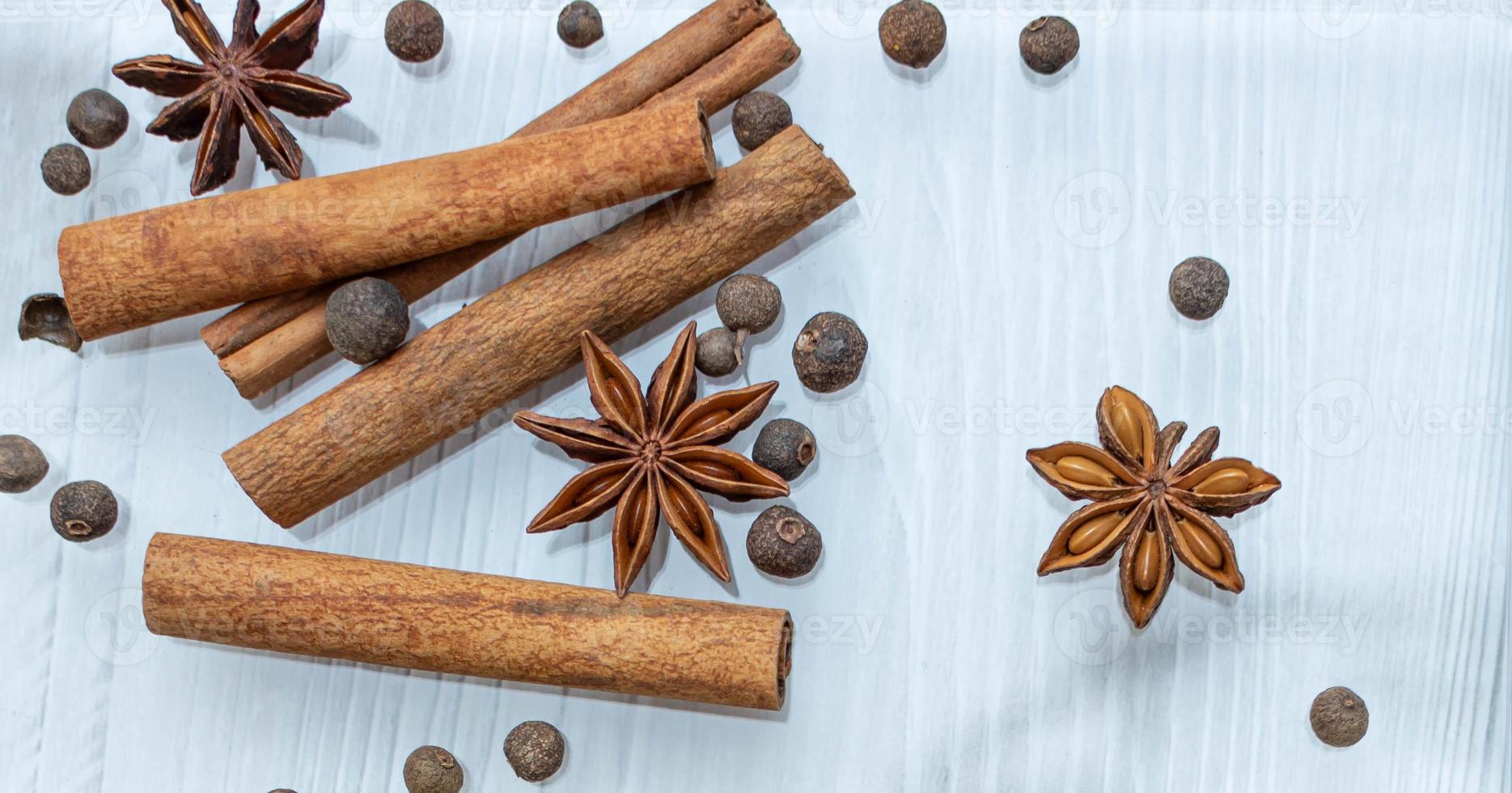 Cooking background, Star anise with cinnamon rolls and sweet peppers photo