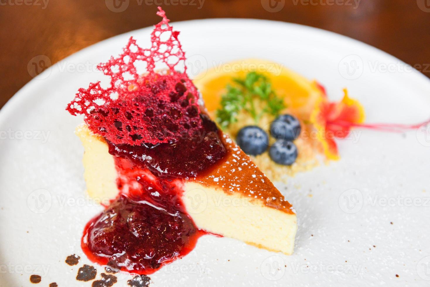 Cheese cake slice with raspberry sauce on withe plate - cheesecake fruit delicious dessert photo