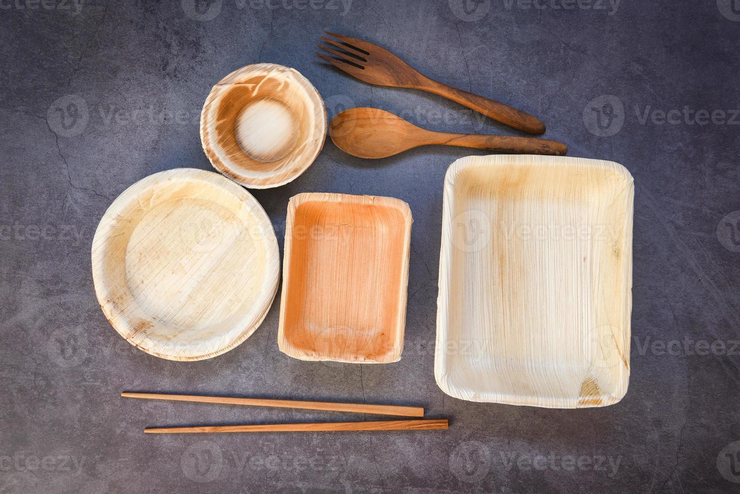 Natural eco-friendly food packaging disposable utensils with dish plate bowl cup and wooden fork spoon Eco friendly disposable tableware from palm leaf or betel nut zero waste environment concept photo