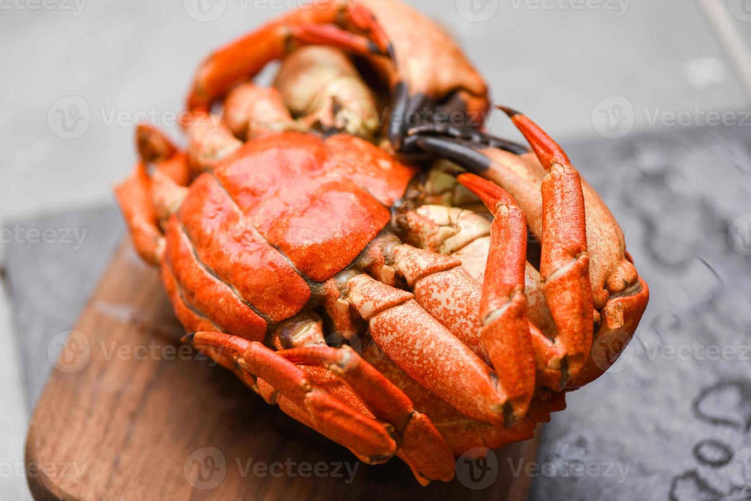Fresh crab on wooden board for making cooked food - Seafood shellfish Steamed red crab or Boiled stone crab photo