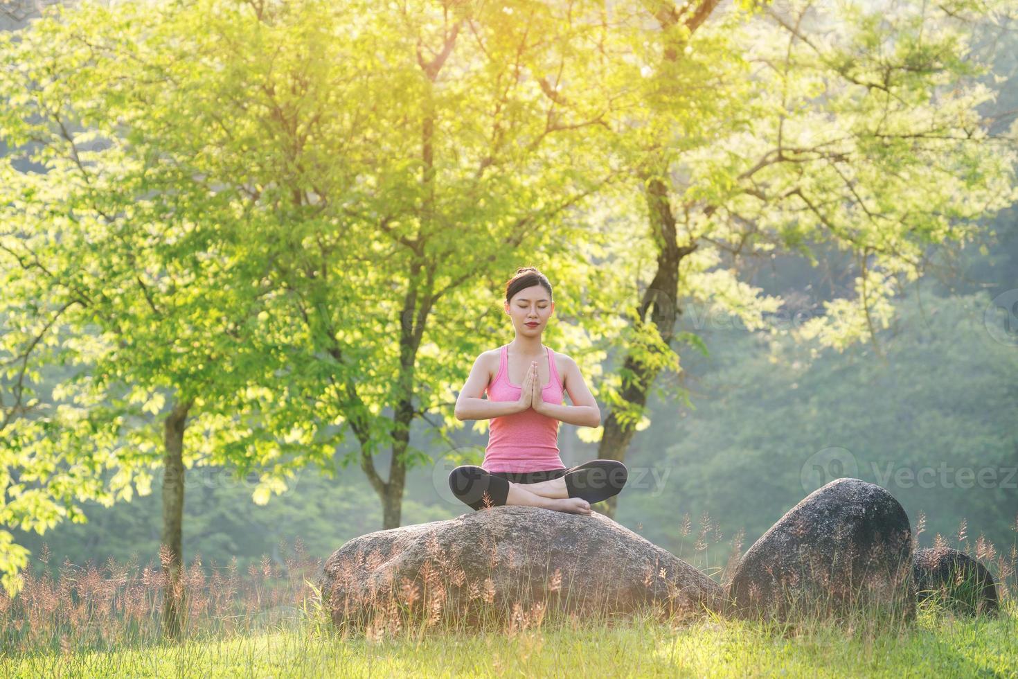 young beautiful asian woman practicing yoga photo