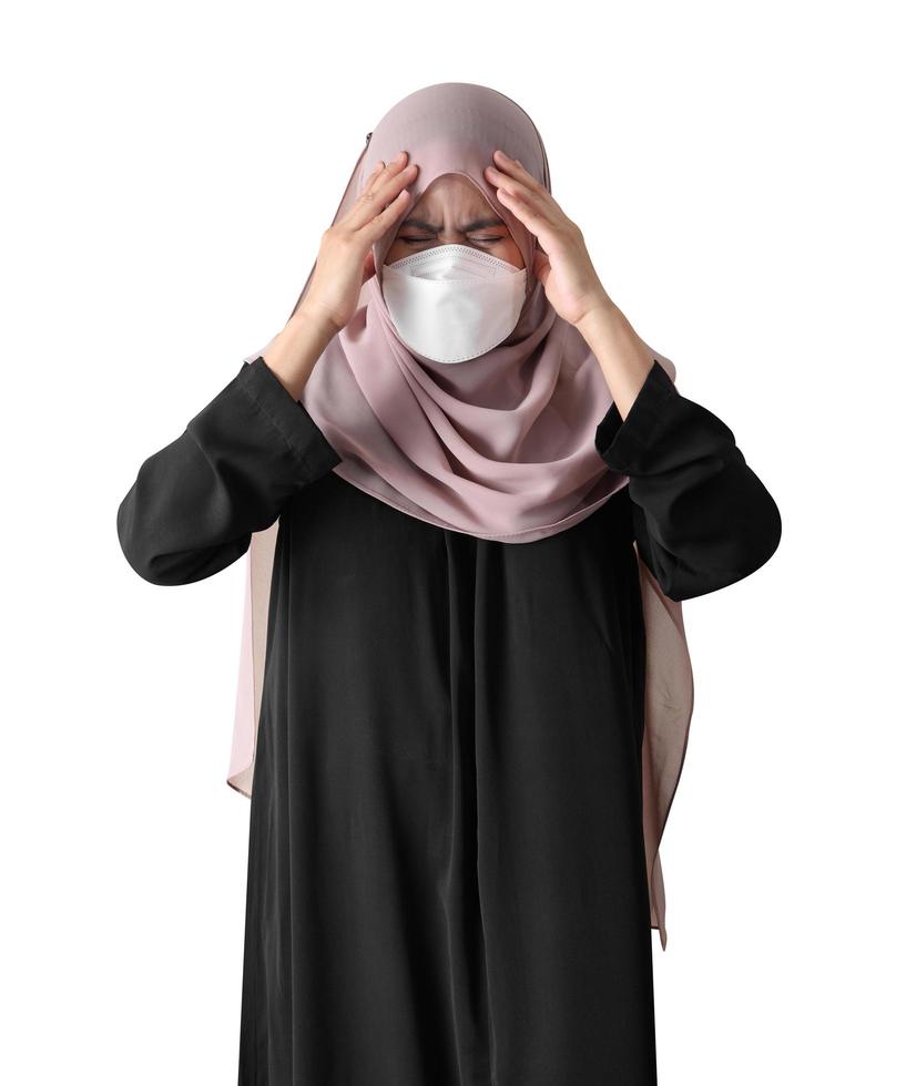 Muslim woman feeling sick standing on white background. Covid-19 coronavirus concept. photo