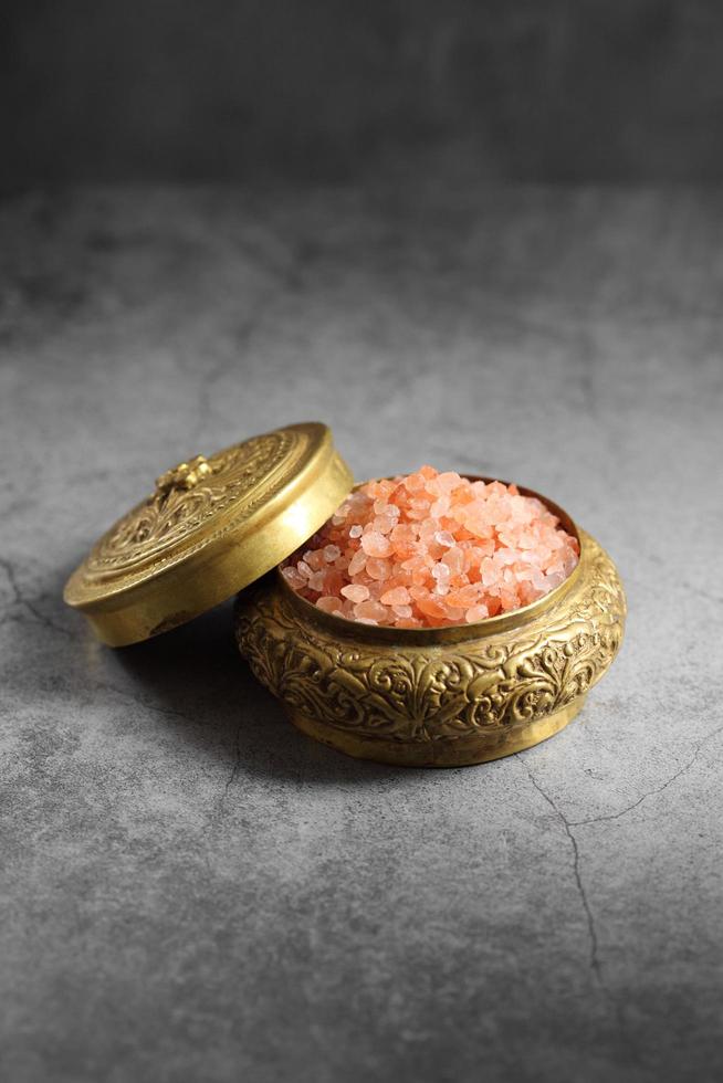 Himalayan pink salt in golden box at kitchen photo