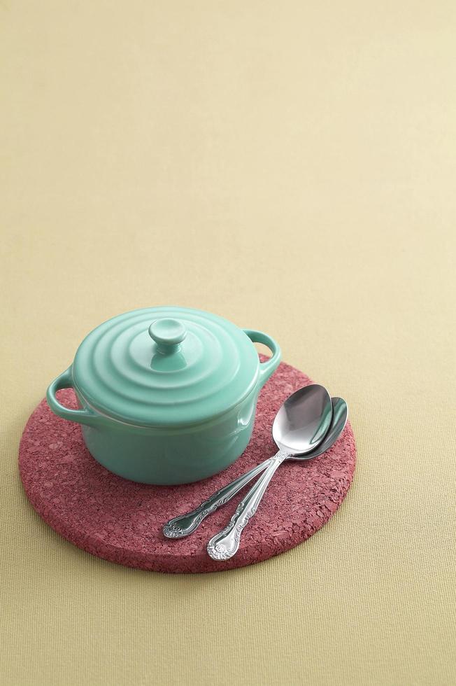 spoon and ceramic cup on pastel background photo