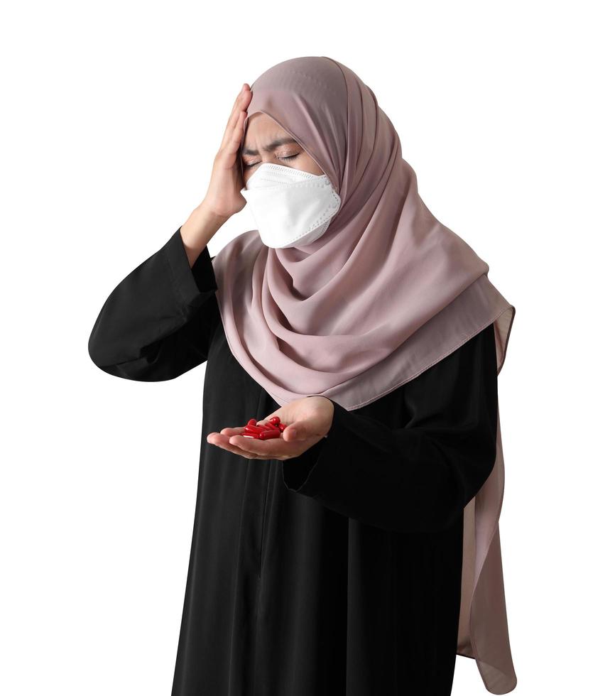 Muslim woman wearing a surgical mask feeling sick on white background photo