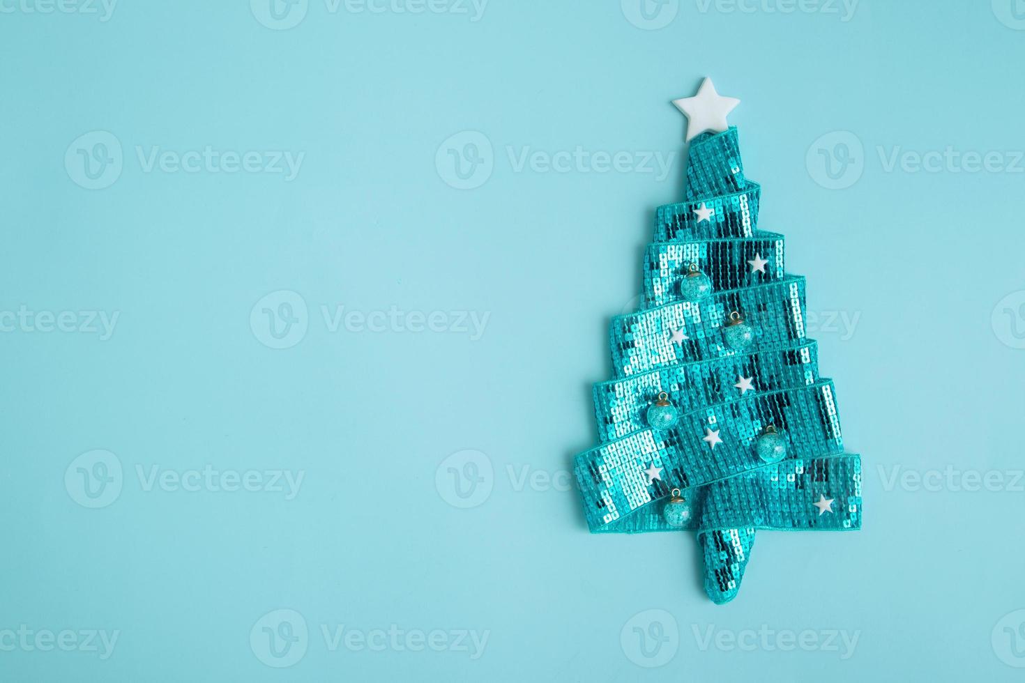 Happy New Year greeting card with abstract shiny Christmas tree made of ribbon. Copy space photo