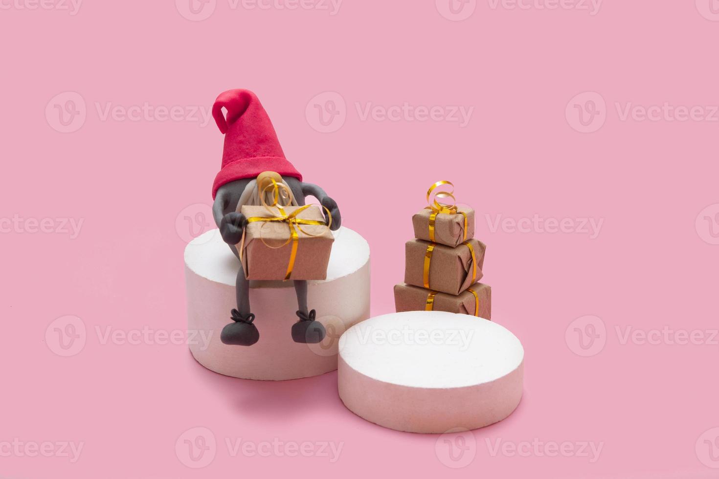 Mock-up product podiums with gnome and gifts on pink background photo