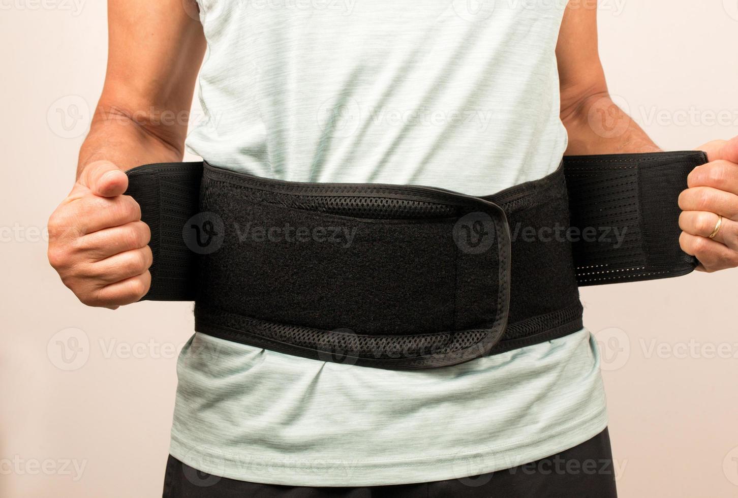 Man wearing a Back Brace for his injured back, Back Pain treatment photo