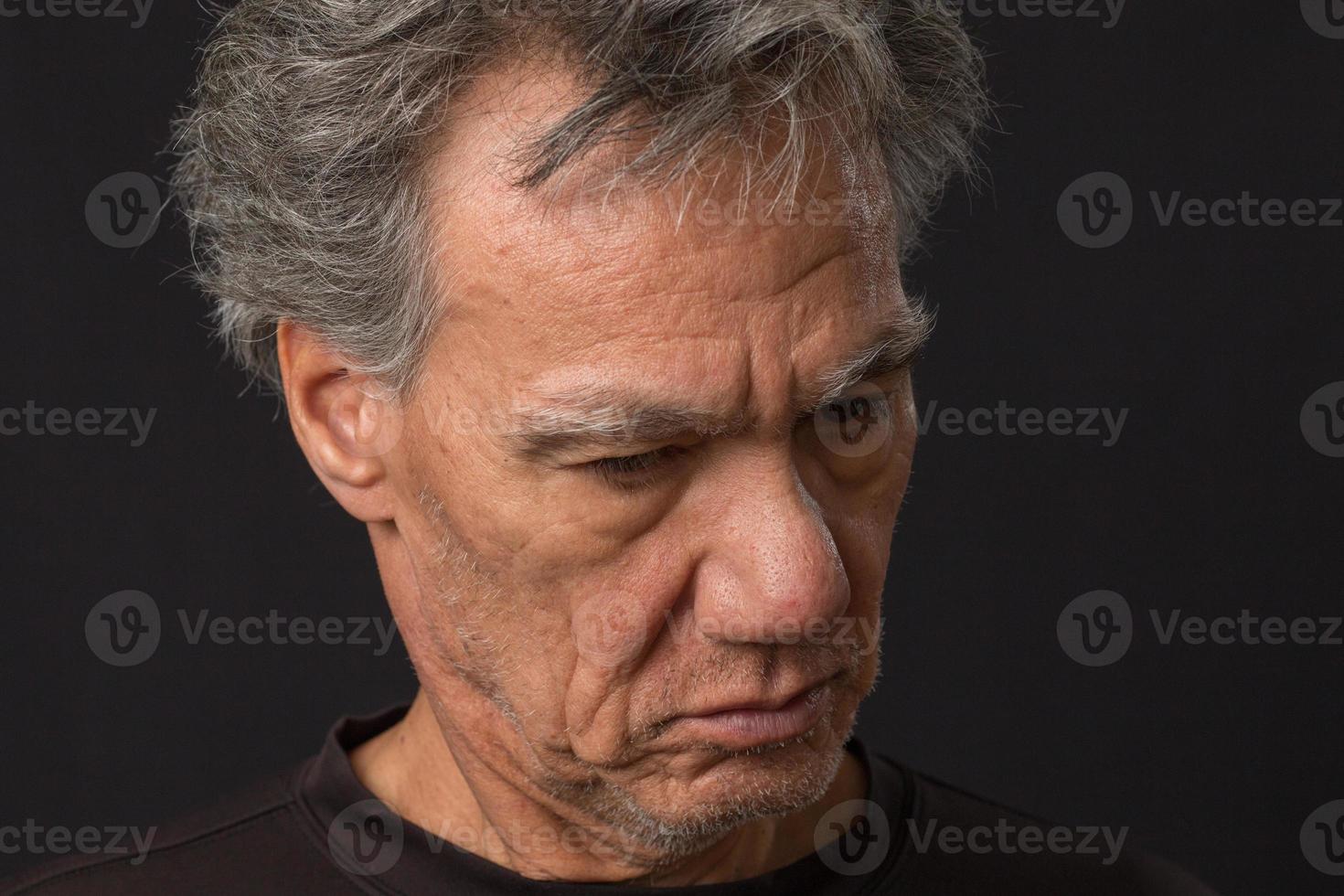 Distraught unshaven senior man at home looking depressed and tired of being locked down photo