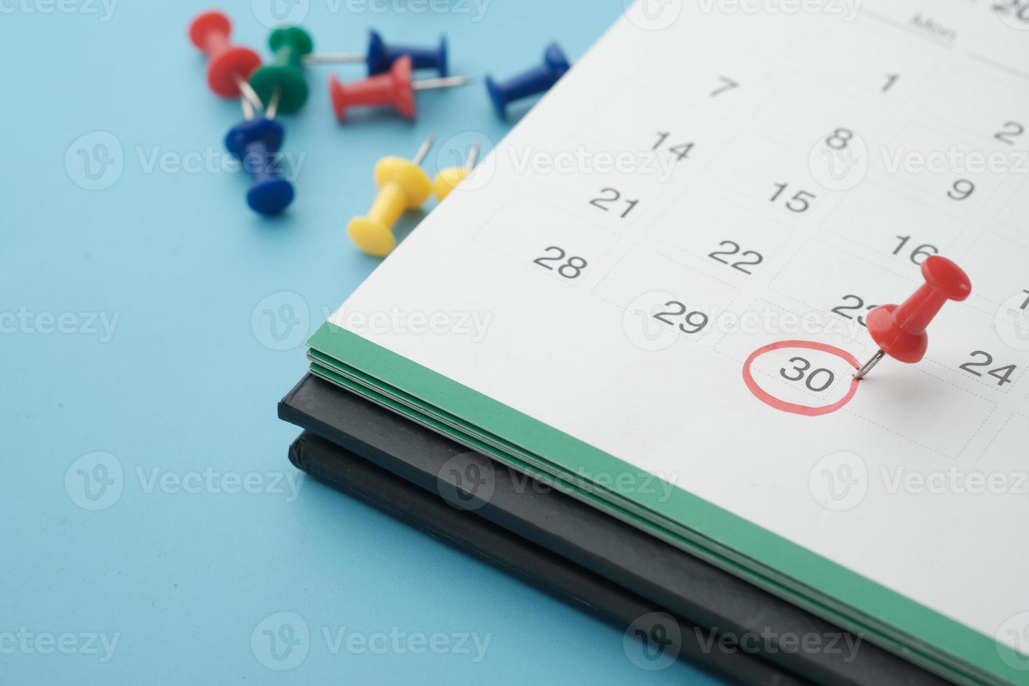 deadline concept with push pin on calendar date close up photo