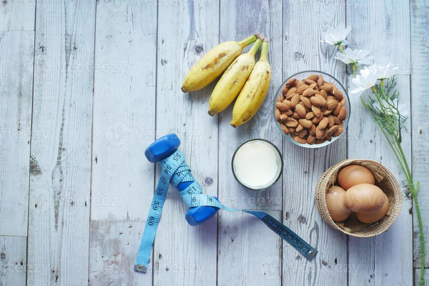 eggs in a plastic container, milk and almond nut in table photo