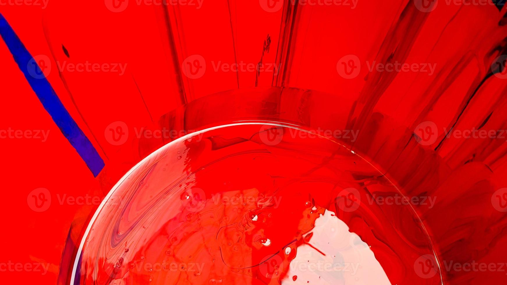 Abstract background of spilled red paint with buckets on a black backdrop. Red paint is pouring on a black background. Use it for an artist or creative concept. paints spilled red colored background photo