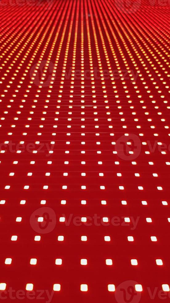 RGB LED screen panel texture. Close-up of a pixel LED screen with bokeh for wallpaper. Bright red abstract background perfect for any design. photo